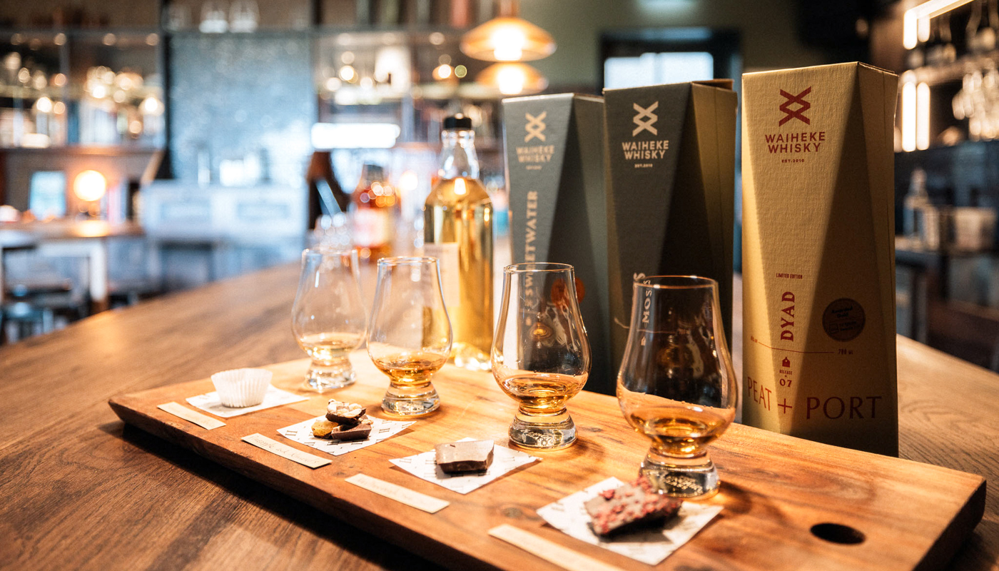Flight of whiskey vessels set up with accompanying chocolate blocks.