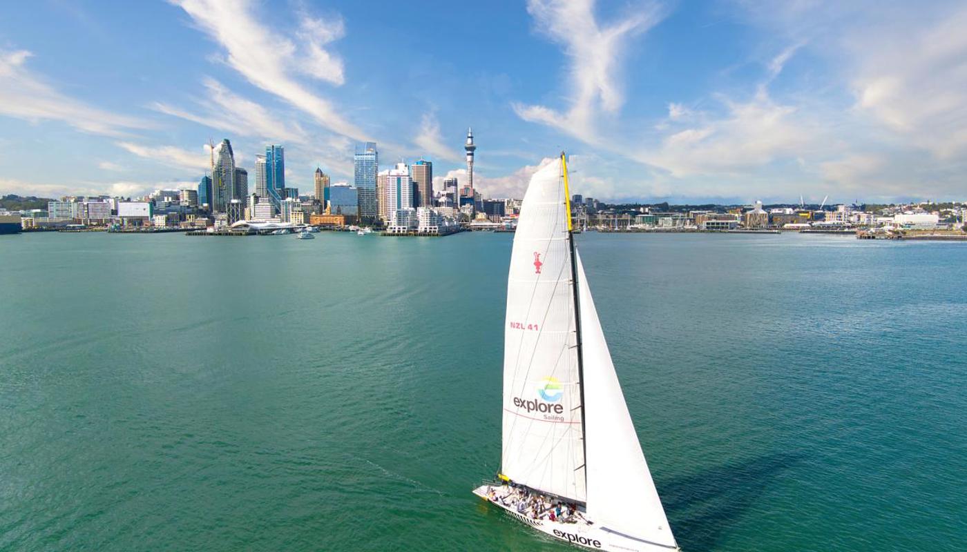 Sailing the Waitematā with Auckland cityscape in background.